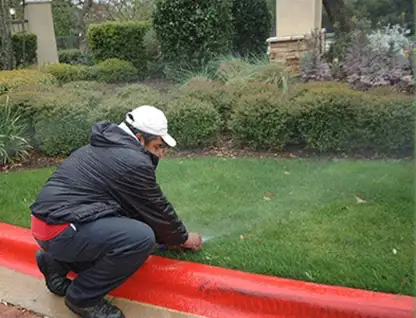 Irrigation technician inspecting sprinkler system