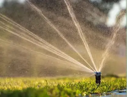Sprinkler head watering lawn